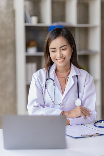 Asian female doctor meeting online speaking at laptop computer working in online clinic to help patients in smart medical telemedicine digital telephony service app