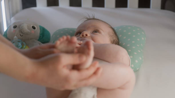 istock Mother touching or doing massage adorable newborn legs 1483184512