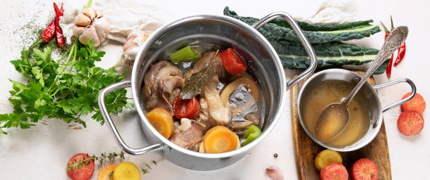 istock Pot of soup with beef and fresh vegetables on a white background. 1483184655