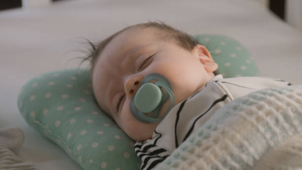 istock Father puts newborn baby in white cradle 1483184661
