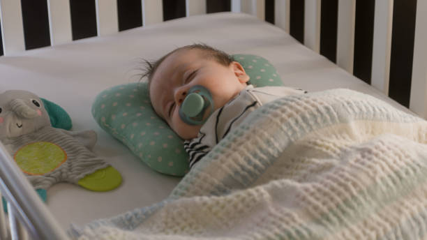 istock Father puts newborn baby in white cradle 1483184684