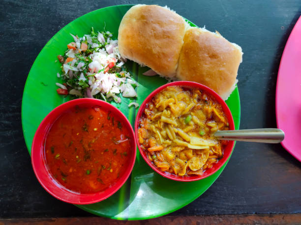 Spicy E.g. Pav or usal Pav Spicy Misal Pav or usal Pav is a traditional snack or Chaat food from Maharashtra, India. Served with chopped onion, lemon kolhapur stock pictures, royalty-free photos & images