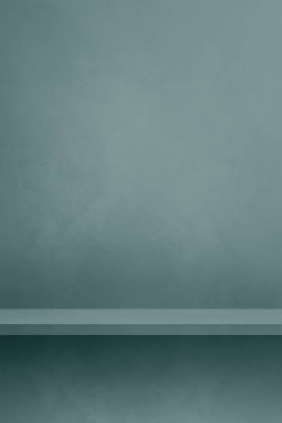 istock Empty shelf on a blue grey concrete wall. Background template. Vertical mockup 1483191251