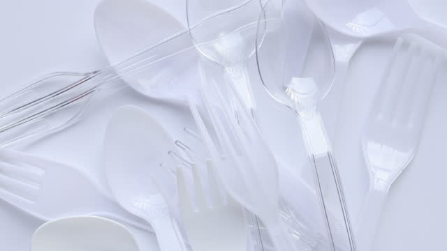 Disposable transparent plastic spoon and fork. Plastic spoon and fork on white background. concept environmental problems.