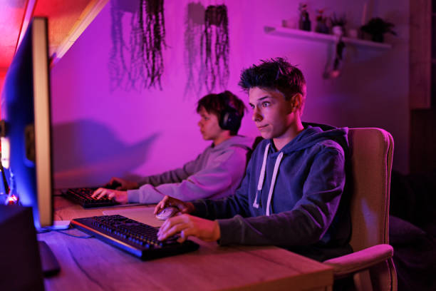 istock Teenage boys playing video game on desktop PC 1483192309