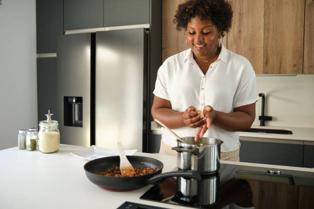 istock Young cuban woman filling mashed potatoes with minced beef. 1483192458