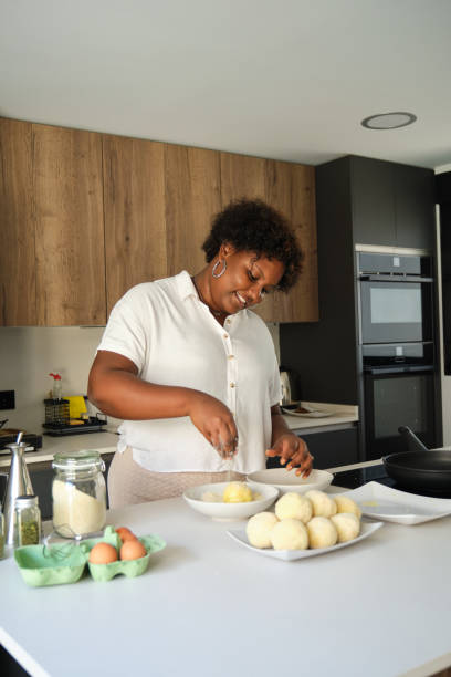 istock Young cuban woman breading mashed potatoes balls. 1483192477