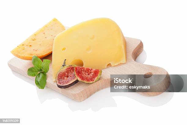 Cheese Variaton On Chopping Board Isolated Stock Photo - Download Image Now - Appetizer, Basil, Brightly Lit