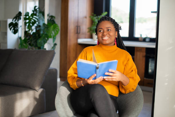 istock Woman relaxing and reading a book 1483197197