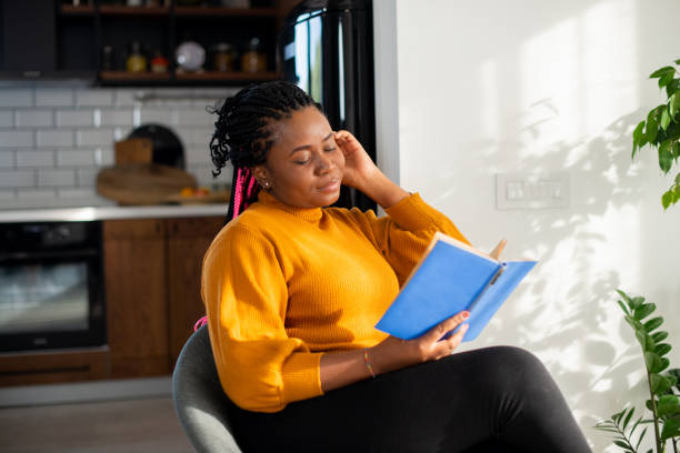 istock Woman relaxing and reading a book 1483197211