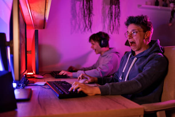 istock Teenage boys playing video game on desktop PC 1483198035