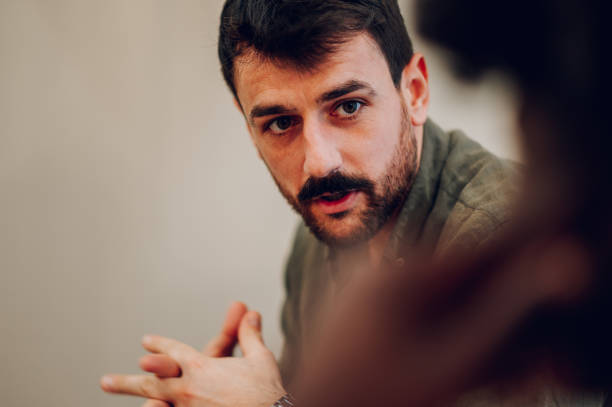 istock Young man talking about his mental health on a group therapy session 1483199142