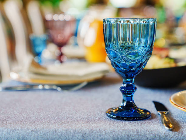 istock glasses of colored glass on a table with a blue tablecloth. 1483199754