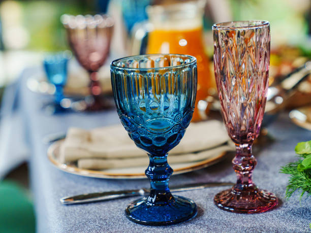 istock glasses of colored glass on a table with a blue tablecloth. 1483200073