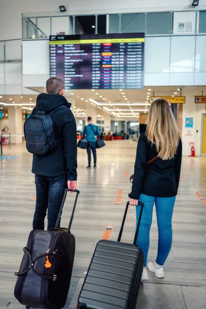 istock Couple check flight at the international airport. 1483200865