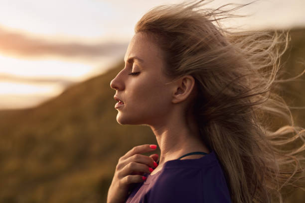 Graceful woman on windy day in nature stock photo