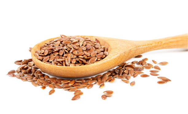 istock Flax seeds in wooden spoon isolated on white background. 1483202489