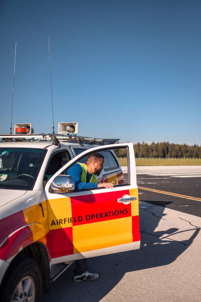 istock Hispanic Airfield Operations Officer Exiting A Follow Me Car 1483202652