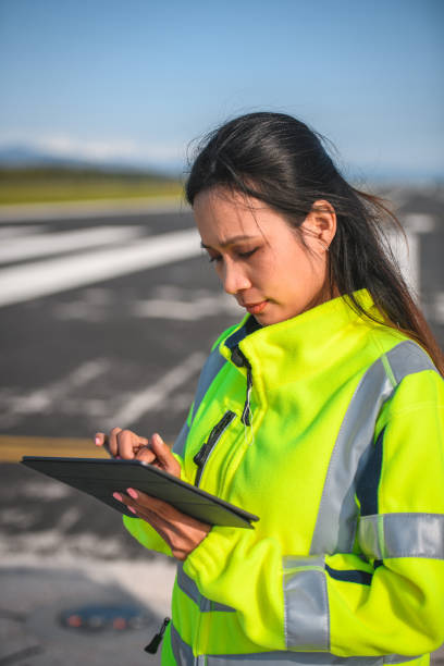 istock Asian Female Airfield Operations Officer Using A Digital Tablet 1483202703