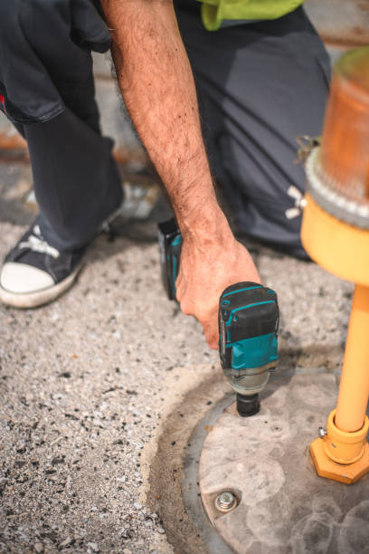 istock Airport Mechanic Changing Elevated Lights On a Runway 1483202899