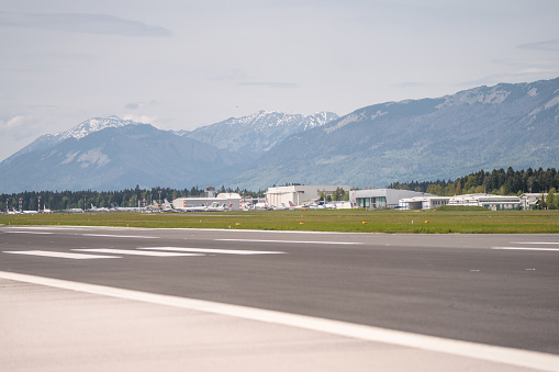 Airfield and an idyllic airport under the alps in the backgroud.