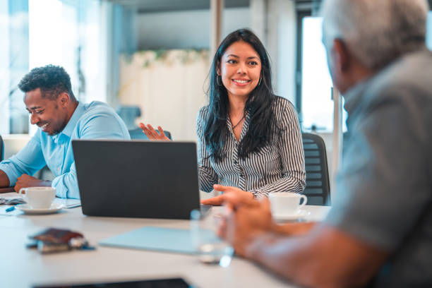 istock Attractive Latin Female Explaining Ideas to Team 1483203150