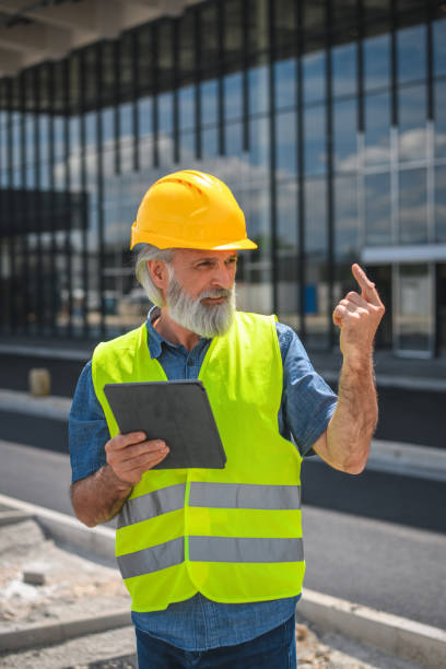 istock Successful Mature Project Leader Working Outdoor In A Construction Site 1483204208
