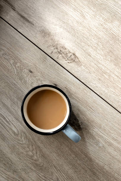 istock Hot coffee drink cup on neutral beige wooden table with sunlight shadows, minimalist aesthetic morning breakfast or coffee break concept, flat lay, copy space 1483204355