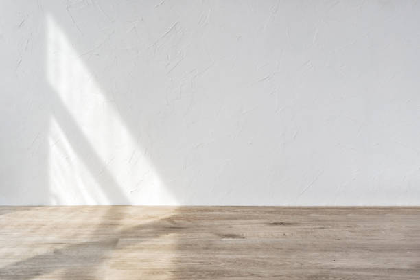 istock Aesthetic geometric sunlight shadows on white textured wall and beige wooden floor, empty template for home room interior product, background for branding design showcase, copy space 1483204610