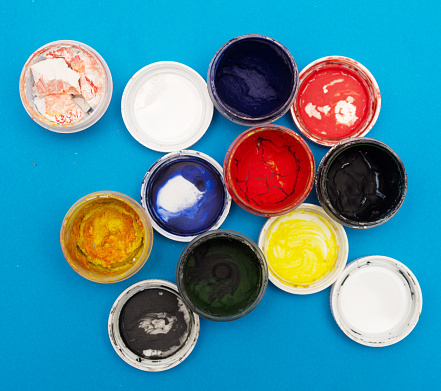 Abstract creativity concept: group of tin metal cans with color paint dye