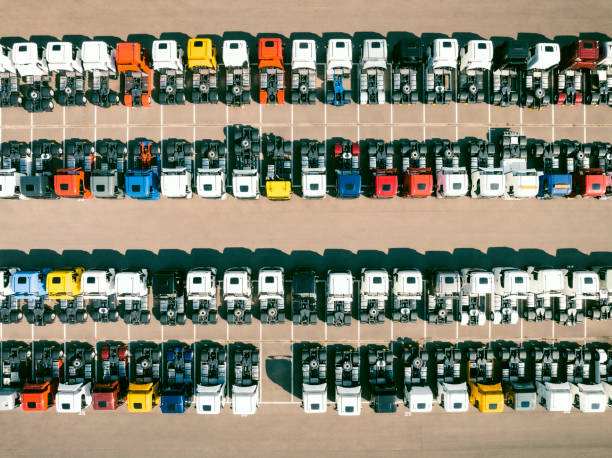 istock Trucks in a row at a parking lot seen from above 1483205758