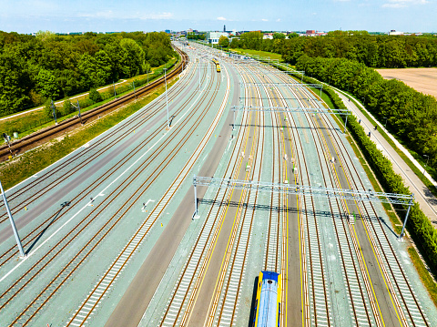 Railroad yard in Zwolle at the Engelse Werk park seen from above during a beautiful summer day. Trains are stationary at the yard for various lines in Overijssel.