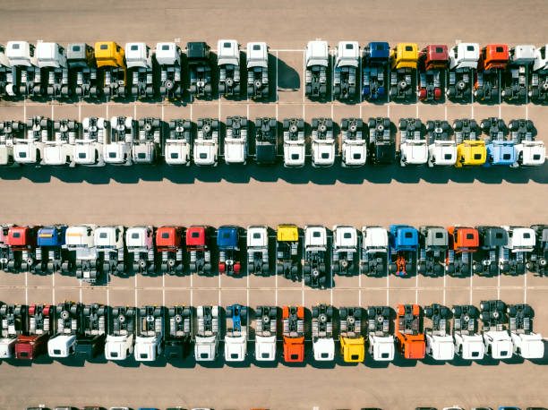 istock Trucks in a row at a parking lot seen from above 1483206115