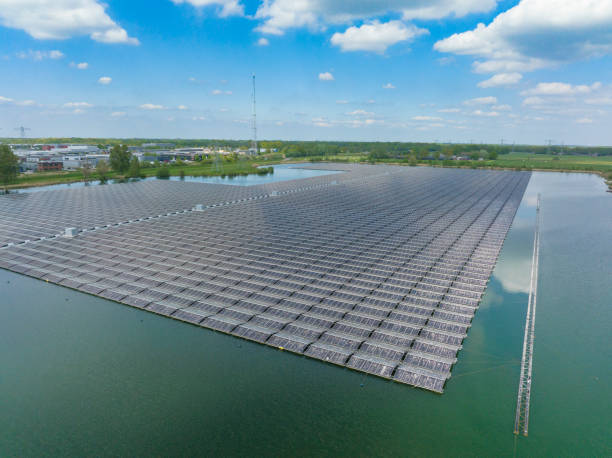 Floating solar farm producing clean renewable electricity energy seen from above Aerial view on a floating solar farm producing clean renewable electricity energy in Flevoland, Netherlands during a sunny day in winter. landscape alternative energy scenics farm stock pictures, royalty-free photos & images