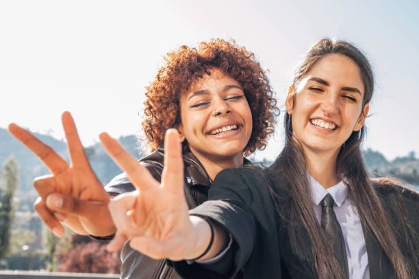 istock smiling girls with victory sign 1483207661