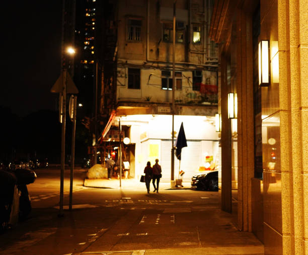 istock Couple walking on the quiet sidewalk at night 1483207868