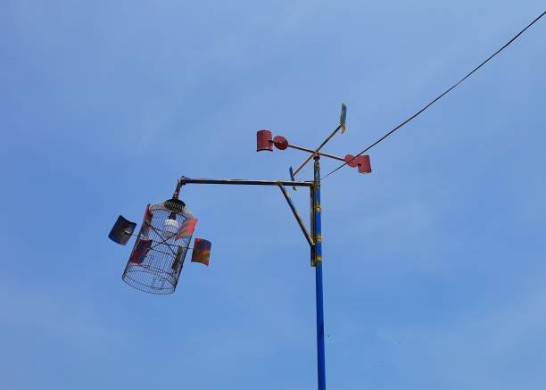 istock Traditional windmills from logs and used cans and decorative lighting with bamboo cages with blue sky background 1483209393