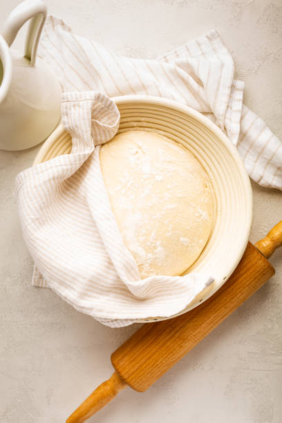 istock Raw yeast dough resting and rising in a special basket on kitchen table 1483209478