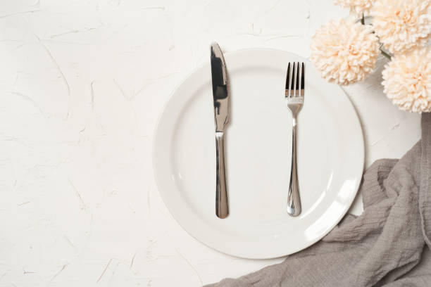 istock food concept stylish table setting cutlery on white table with silver fork and knife. top view or flat lay 1483212835