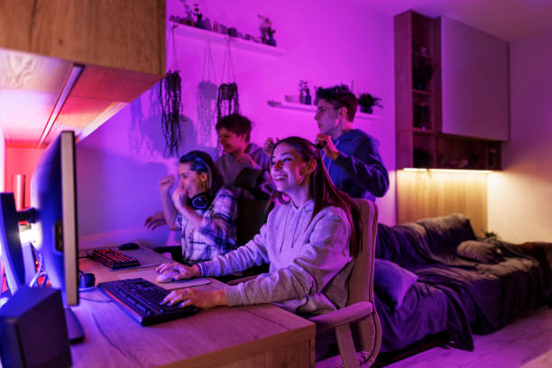 istock Mother and teenagers playing video game on desktop PC 1483216216