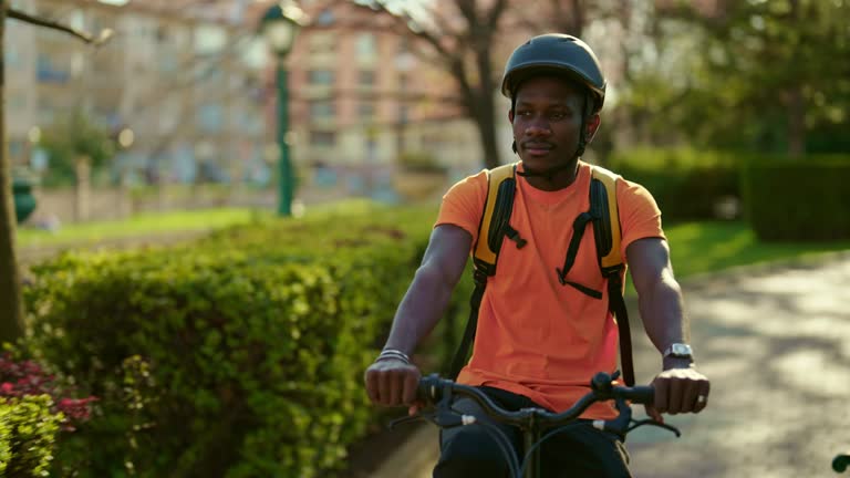 Young man riding a bike in a park