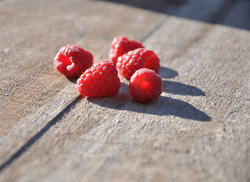 Close-up of fresh raspberries on wooden table