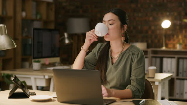 Asian business woman, laptop and drinking coffee in night for planning, deadline help or email communication. Japanese female, burnout and computer with matcha, espresso or latte for working overtime