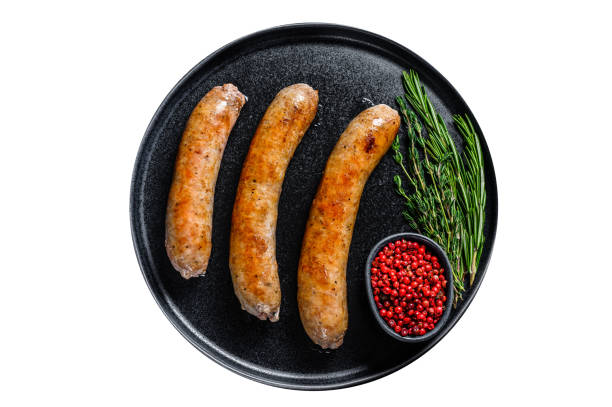 istock Sausages fried with spices and herbs on a plate.   Isolated on white background. 1483220748