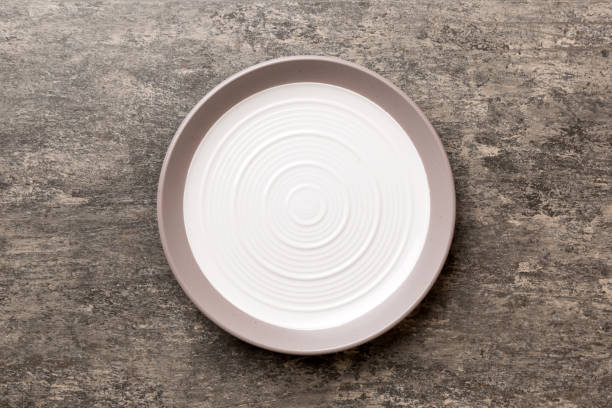 istock Top view of empty light plate on cement background. Empty space for your design 1483220909