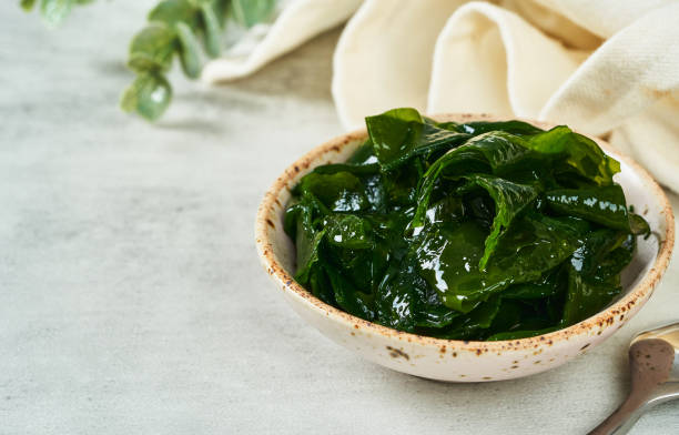 istock close up laminaria (Kelp) seaweed in a bowl on white background with copy space 1483220930