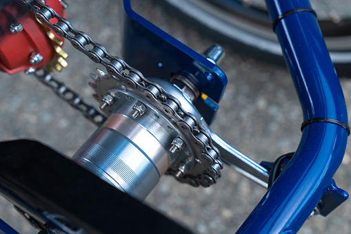 Rear axle of a bicycle with chain and gear. Close up.