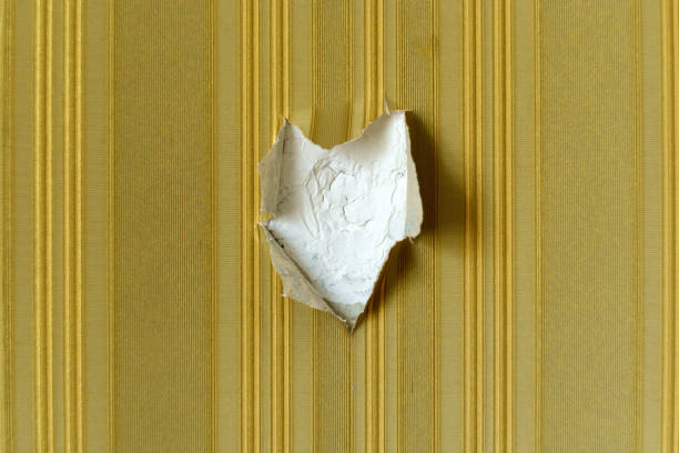 Large hole in damaged drywall, in need of repair. plaster patch, background texture