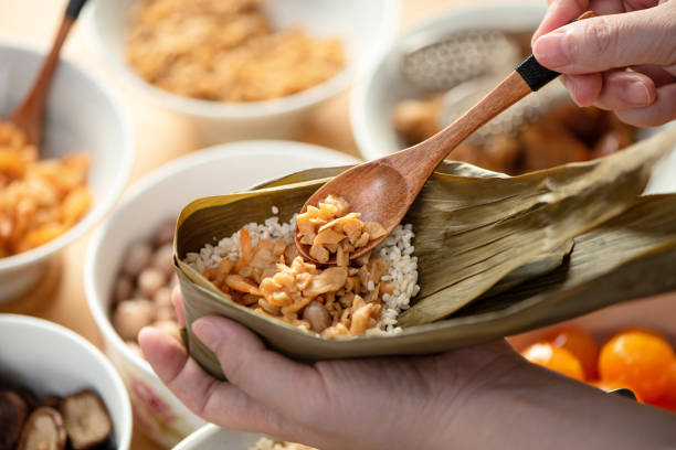 istock Making zongzi food - preparing and wrapping Chinese rice dumpling. 1483221724
