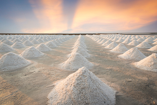 Sea salt pile pyramid ready for harvest in salt farm. Sea salt is salt that is produced by the evaporation of seawater